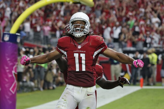 Arizona Cardinals wide receiver Larry Fitzgerald (11) celebrates his touchdown against the Washington Redskins during the first half of an NFL football game, Sunday, Oct. 12, 2014, in Glendale, Ariz. (AP Photo/Ross D. Franklin)