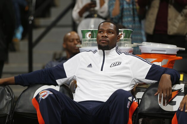 Oklahoma City Thunder forward Kevin Durant sits on bench before facing Denver Nuggets in the first quarter of an NBA exhibition basketball game in Denver on Wednesday, Oct. 8, 2014. (AP Photo/David Zalubowski)