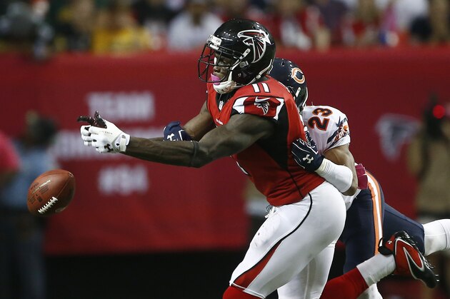 Atlanta Falcons wide receiver Julio Jones (11) vies for a passed ball as Chicago Bears cornerback Kyle Fuller (23) defends during the second half of an NFL football game, Sunday, Oct. 12, 2014, in Atlanta. (AP Photo/John Bazemore)