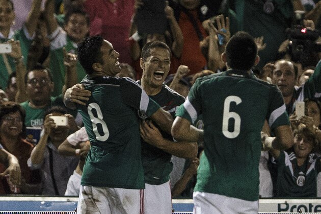 Mexico's Javier Hernandez, center, celebrates with Marco Fabian, left and Miguel Herrera after scoring against Honduras during a friendly soccer match, in Tuxtla Gutierrez, Thursday, Oct. 9, 2014. (AP Photo/Christian Palma)