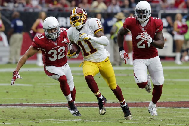 Washington Redskins wide receiver DeSean Jackson (11) runs for a touchdown as Arizona Cardinals free safety Tyrann Mathieu (32) and Patrick Peterson (21) pursue during the first half of an NFL football game, Sunday, Oct. 12, 2014, in Glendale, Ariz.(AP Photo/Rick Scuteri)