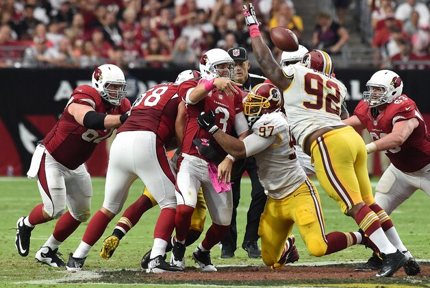GLENDALE, AZ - OCTOBER 12:  Quarterback Carson Palmer #3 of the Arizona Cardinals is hit by defensive end Jason Hatcher #97 of the Washington Redskins during the second half of the NFL game at University of Phoenix Stadium on October 12, 2014 in Glendale, Arizona.  (Photo by Norm Hall/Getty Images)