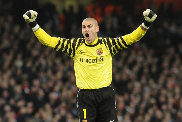 Barcelona's goalkeeper Victor Valdes, reacts after David Villa, unseen, scored a goal against Arsenal during a Champions League, round of 16, first leg soccer match at Arsenal's Emirates stadium in London, Wednesday, Feb. 16, 2011. (AP Photo/Bogdan Maran)