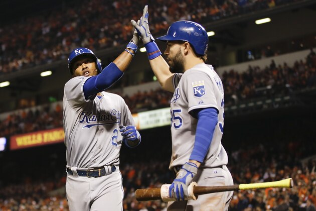 Kansas City Royals' Alcides Escobar (2) is congratulated by Eric Hosmer after scoring during the ninth inning of Game 2 of the American League baseball championship series against the Baltimore Orioles Saturday, Oct. 11, 2014, in Baltimore. (AP Photo/Matt Slocum)
