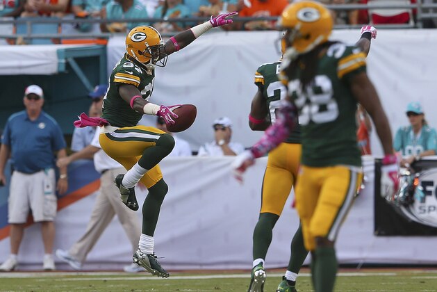 MIAMI GARDENS, FL - OCTOBER 12:  Cornerback Sam Shields #37 of the Green Bay Packers (L) reacts after intercepting a Miami Dolphins pass in the second quarter during a game  at Sun Life Stadium on October 12, 2014 in Miami Gardens, Florida.  (Photo by Mike Ehrmann/Getty Images)