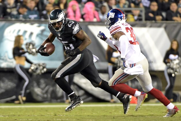 Oct 12, 2014; Philadelphia, PA, USA; Philadelphia Eagles running back LeSean McCoy (25) tries to turn the corner against New York Giants cornerback Trumaine McBride (38) during the second quarter at Lincoln Financial Field. Mandatory Credit: Eric Hartline-USA TODAY Sports