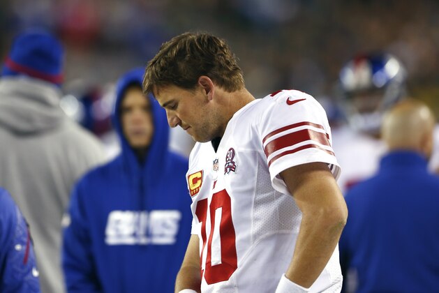 New York Giants quarterback Eli Manning stands on the sideline during the second half of an NFL football game against the Philadelphia Eagles, Sunday, Oct. 12, 2014, in Philadelphia. (AP Photo/Matt Rourke)