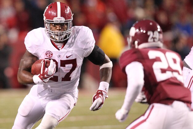 Oct 11, 2014; Fayetteville, AR, USA; Alabama Crimson Tide running back Derrick Henry (27) rushes during the fourth quarter as Arkansas Razorbacks cornerback Jared Collins (29) defends at Donald W. Reynolds Razorback Stadium. Alabama defeated Arkansas 14-13. Mandatory Credit: Nelson Chenault-USA TODAY Sports