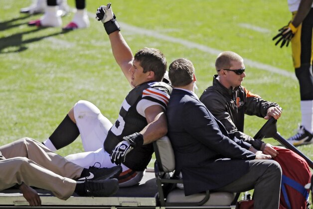 Cleveland Browns center Alex Mack gives a thumbs-upto the crowd as he is taken off the field with an injury in the second quarter of an NFL football game against the Pittsburgh Steelers, Sunday, Oct. 12, 2014, in Cleveland. The Browns won 31-10. (AP Photo/Tony Dejak)