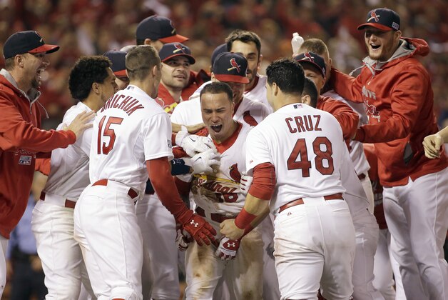 St. Louis Cardinals' Kolten Wong is congratulated after hitting a walk off home run during the ninth inning in Game 2 of the National League baseball championship series against the San Francisco Giants Sunday, Oct. 12, 2014, in St. Louis. The  Cardinals won 5-4. (AP Photo/David J. Phillip)