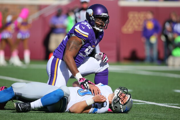 MINNEAPOLIS, MN - OCTOBER 12:  Quarterback Matthew Stafford #9 of the Detroit Lions lays on the ground after being hit by Tom Johnson #92 of the Minnesota Vikings during the first quarter on October 12, 2014 at TCF Bank Stadium in Minneapolis, Minnesota. (Photo by Adam Bettcher/Getty Images)