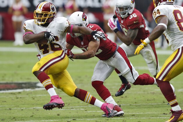 Washington Redskins running back Alfred Morris (46) escapes the reach of Arizona Cardinals strong safety Tony Jefferson during the first half of an NFL football game, Sunday, Oct. 12, 2014, in Glendale, Ariz. (AP Photo/Ross D. Franklin)