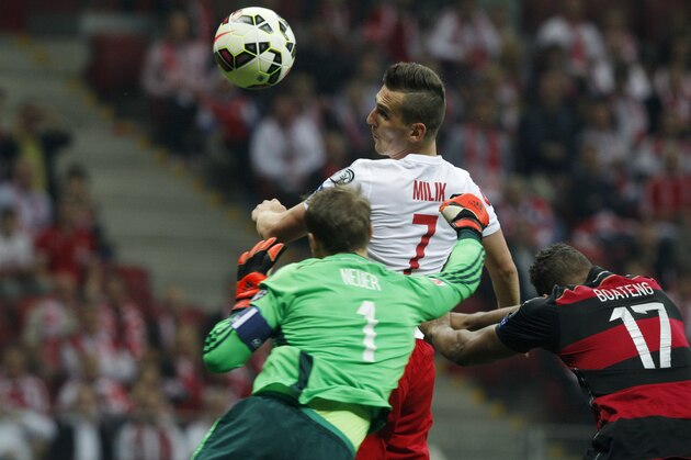 Poland's Arkadiusz Milik, center, scores the opening goal past Germany's goalkeeper Manuel Neuer, left, and Jerome Boateng during a Euro 2016 group D qualifying soccer match between Poland and Germany in Warsaw, Poland,Saturday, Oct. 11, 2014. (AP Photo/Czarek Sokolowski)