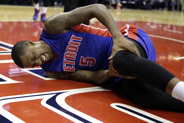 Detroit Pistons guard Kentavious Caldwell-Pope holds his knee after falling in the second half of a preseason NBA basketball game against the Washington Wizards, Sunday, Oct. 12, 2014, in Washington. The Wizards won 91-89. (AP Photo/Alex Brandon)