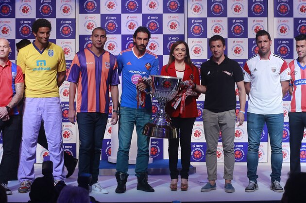 Indian Super League (ISL) founding chairperson Nita Ambani, center, poses with `players from left, Swedish footballer Fredrik Ljungberg who will play for the Mumbai team, English footballer David James, who will play for the Kerala Blasters team, French footballer David Trezeguet, who will play for the Pune team, French footballer Robert Pires who will play for the Goa team, Italian footballer Alessandro Del Piero, who will play for the Delhi Dynamos team, Spanish footballer Joan Capdevila, who will play for the North East United team, Spanish footballer Luis García, who will play for the Atlético de Kolkata team and French footballer Mikaël Silvestre who will play for the Chennaiyin team during the unveiling of the ISL trophy in Mumbai, India, Sunday, Oct. 5, 2014. The eight-team ISL kicks off on Oct.12. (Staffing/Rafiq Maqbool)