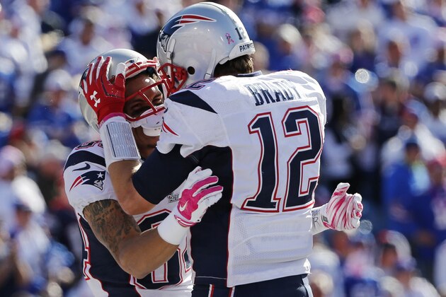 New England Patriots quarterback Tom Brady (12) celebrates a touchdown with Brian Tyms (84) during the first half of an NFL football game against the Buffalo Bills Sunday, Oct. 12, 2014, in Orchard Park, N.Y. (AP Photo/Mike Groll)
