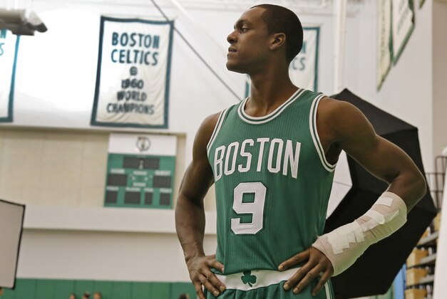 Boston Celtics guard Rajon Rondo poses with his broken hand in a cast for the team photographer during NBA basketball media day in Waltham, Mass., Monday, Sept. 29, 2014. (AP Photo/Elise Amendola)