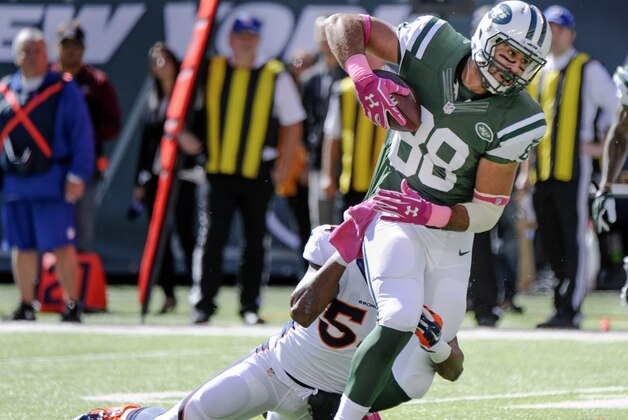 New York Jets tight end Jace Amaro (88) is tackled by Denver Broncos outside linebacker Brandon Marshall (54) in the first quarter of an NFL football game, Sunday, Oct. 12, 2014, in East Rutherford, N.J. (AP Photo/Bill Kostroun)