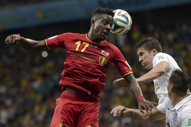 Belgium's Divock Origi heads the ball over United States' Matt Besler and Geoff Cameron, right, during the World Cup round of 16 soccer match between Belgium and the USA at the Arena Fonte Nova in Salvador, Brazil, Tuesday, July 1, 2014. (AP Photo/Marcio Jose Sanchez)