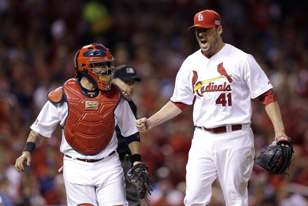 St. Louis Cardinals pitcher John Lackey, right, reacts with catcher Yadier Molina after throwing out Los Angeles Dodgers' Carl Crawford at first base during the fourth inning of Game 3 of baseball's NL Division Series, Monday, Oct. 6, 2014, in St. Louis. (AP Photo/Jeff Roberson)