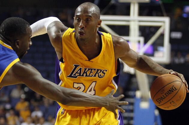 Los Angeles Lakers guard Kobe Bryant, right, drives against Golden State Warriors forward Draymond Green (23) during the first half of a preseason NBA basketball game, Sunday, Oct. 12, 2014, in Ontario, Calif. (AP Photo/Alex Gallardo)