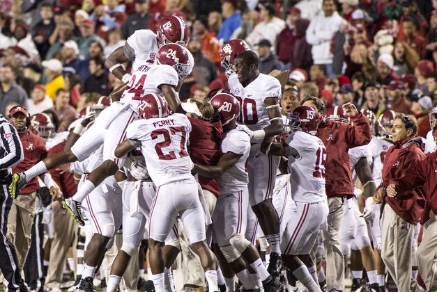 Oct 11, 2014; Fayetteville, AR, USA; Alabama Crimson Tide players react to an interception by defensive back Landon Collins (26) during the second half of a game against the Arkansas Razorbacks at Donald W. Reynolds Razorback Stadium. The Crimson Tide won 14-13. Mandatory Credit: Beth Hall-USA TODAY Sports