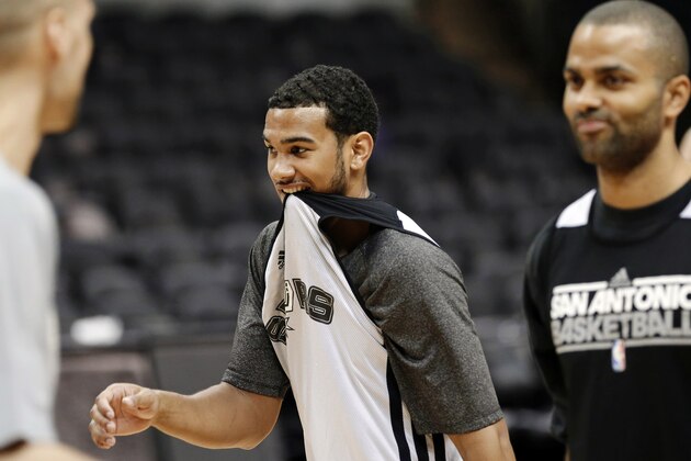San Antonio Spurs' Cory Joseph, left, bites his shirt as teammate Tony Parker stands by during NBA basketball practice, Saturday, June 15, 2013, in San Antonio. The Spurs host the Miami Heat in Game 5 of the NBA Finals on Sunday, with the best-of-seven games series even at 2-2. (AP Photo/David J. Phillip)