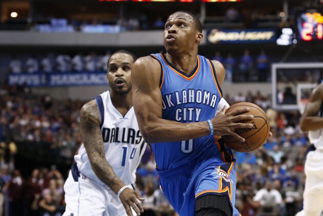 Oklahoma City Thunder guard Russell Westbrook (0) drives the ball to the basket in front of Dallas Mavericks guard Jameer Nelson (14) during the first half of a preseason NBA basketball game, Friday, Oct. 10, 2014, in Dallas. (AP Photo/Jim Cowsert)