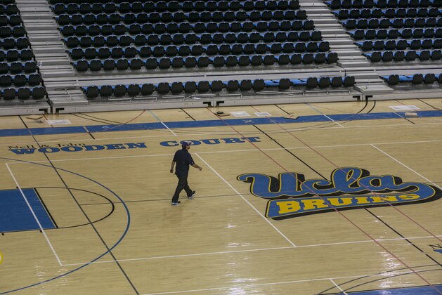 The court at Pauley Pavilion, home of UCLA basketball, is viewed Thursday, July 31, 2014, on the school's campus after Tuesday's flooding from a ruptured pipe under nearby Sunset Boulevard inundated a large area of the campus in the Westwood section of Los Angeles. UCLA Vice Chancellor Kelly Schmader said 8 to 10 inches of water covered the basketball court, and it shows some signs of buckling. (AP Photo/Damian Dovarganes)