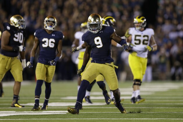 Notre Dame linebacker Jaylon Smith celebrates a tackle for a loss against Michigan during the second half of an NCAA college football game in South Bend, Ind., Saturday, Sept. 6, 2014. (AP Photo/Michael Conroy)