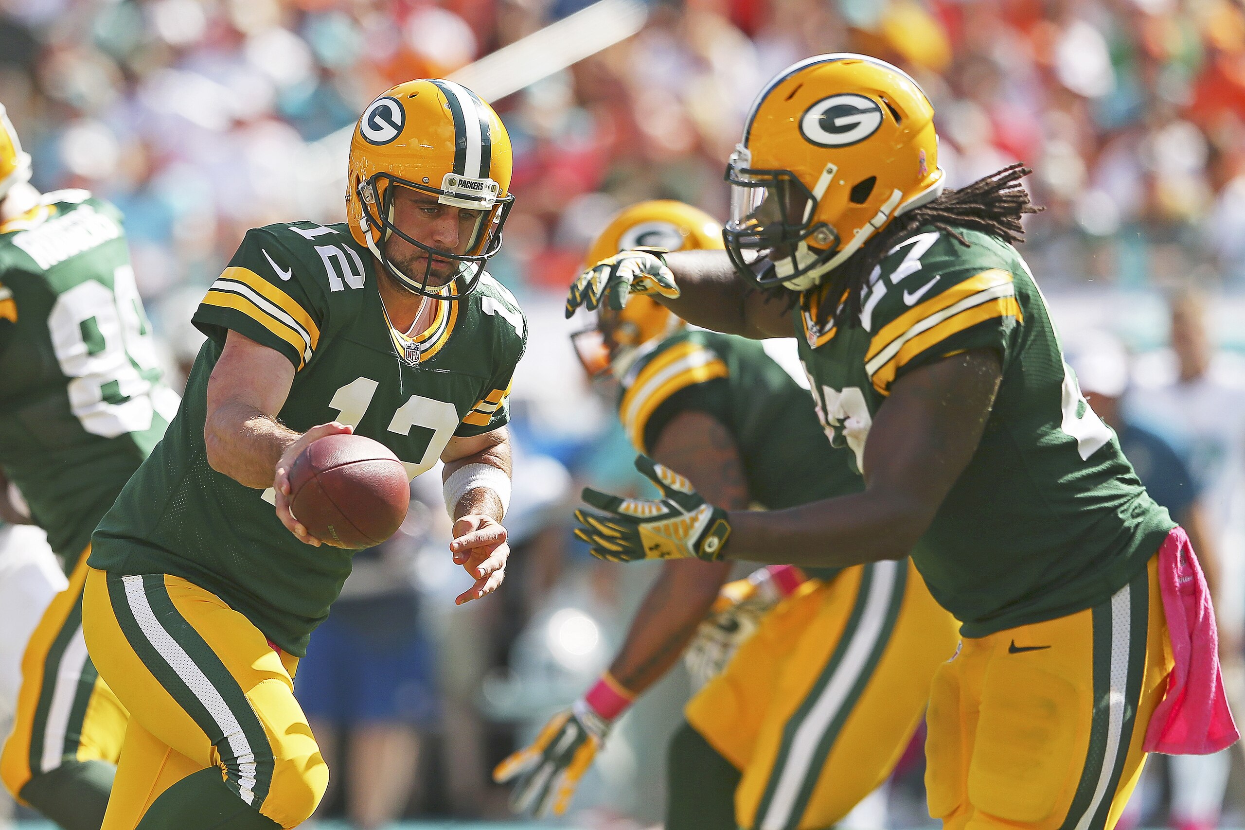 MIAMI GARDENS, FL - OCTOBER 12:  Quarterback Aaron Rodgers #12 of the Green Bay Packers hands off to running back Eddie Lacy #27 in the fourth quarter during a game against the Miami Dolphins at Sun Life Stadium on October 12, 2014 in Miami Gardens, Florida.  (Photo by Mike Ehrmann/Getty Images)