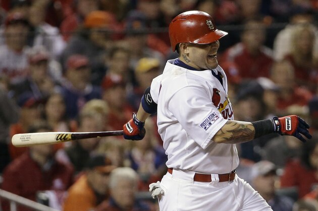 St. Louis Cardinals' Yadier Molina grimaces as he hits into a double play during the sixth inning in Game 2 of the National League baseball championship series against the San Francisco Giants Sunday, Oct. 12, 2014, in St. Louis. (AP Photo/David J. Phillip)