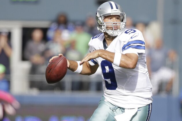 Dallas Cowboys quarterback Tony Romo passes in the first half of an NFL football game against the Seattle Seahawks, Sunday, Oct. 12, 2014, in Seattle. (AP Photo/Elaine Thompson)