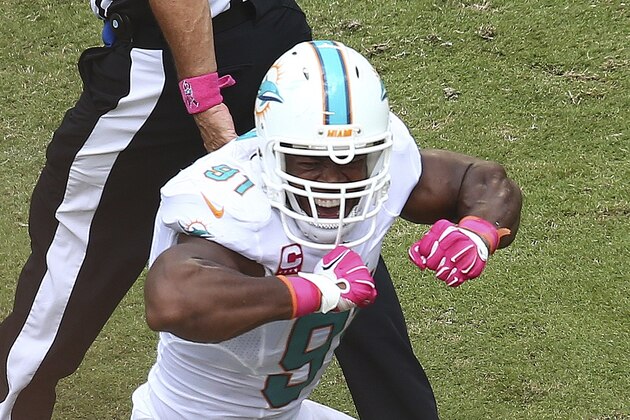 Miami Dolphins' Cameron Wake reacts after sacking Green Bay Packers quarterback Aaron Rodgers during the first half of a NFL football game in Miami Gardens, Fla., Sunday, Oct. 12, 2014. (AP Photo/J Pat Carter)