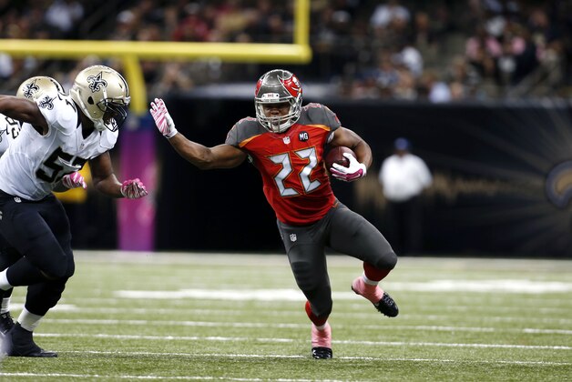 Tampa Bay Buccaneers running back Doug Martin (22) carries against New Orleans Saints inside linebacker David Hawthorne (57) in the second half of an NFL football game in New Orleans, Sunday, Oct. 5, 2014. (AP Photo/Jonathan Bachman)