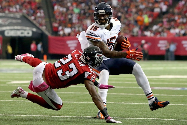 Oct 12, 2014; Atlanta, GA, USA; Chicago Bears wide receiver Brandon Marshall (15) eludes a tackle by Atlanta Falcons cornerback Robert Alford (23) after a reception in the first quarter of their game at the Georgia Dome. Mandatory Credit: Jason Getz-USA TODAY Sports