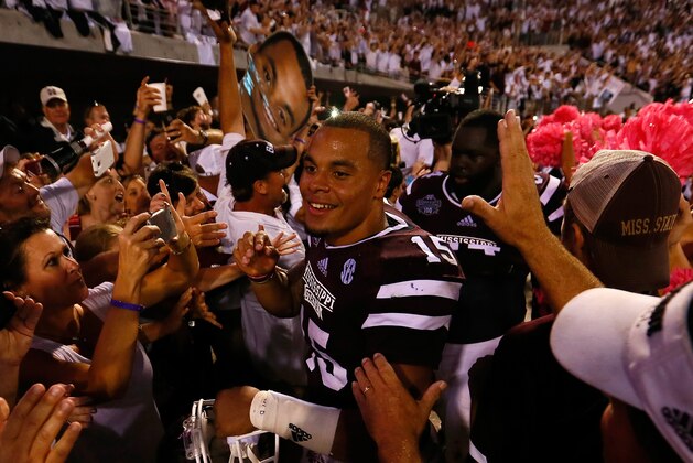 STARKVILLE, MS - OCTOBER 11:  Dak Prescott #15 of the Mississippi State Bulldogs celebrates with fans after their 38-23 win over the Auburn Tigers at Davis Wade Stadium on October 11, 2014 in Starkville, Mississippi.  (Photo by Kevin C. Cox/Getty Images)