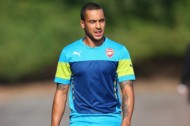 ST ALBANS, ENGLAND - SEPTEMBER 30:  Theo Walcott of Arsenal walks out for training during an Arsenal training session ahead of their UEFA Champions League Group D match against Galatasaray at London Colney on September 30, 2014 in St Albans, England.  (Photo by Paul Gilham/Getty Images)
