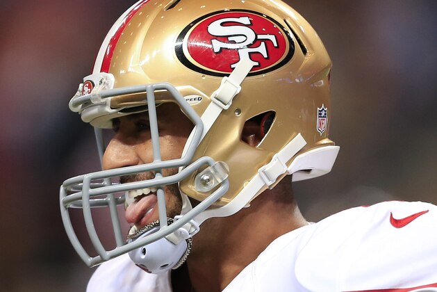 San Francisco 49ers quarterback Colin Kaepernick (7) laughs as he runs to the bench after throwing a touchdown pass against the St. Louis Rams in the third quarter of an NFL football game Monday, Oct. 13, 2014, in St Louis. (AP Photo/Billy Hurst)