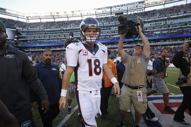 Denver Broncos quarterback Peyton Manning (18) walks off the field after the Broncos beat the New York Jets 31-17 in an NFL football game, Sunday, Oct. 12, 2014, in East Rutherford, N.J. (AP Photo/Kathy Willens)