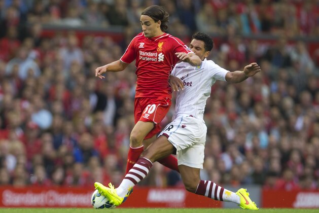 Liverpool's Lazar Markovic, left, is tackled by Aston Villa's Kieran Richardson during their English Premier League soccer match at Anfield Stadium, Liverpool, England, Saturday Sept. 13, 2014. (AP Photo/Jon Super)
