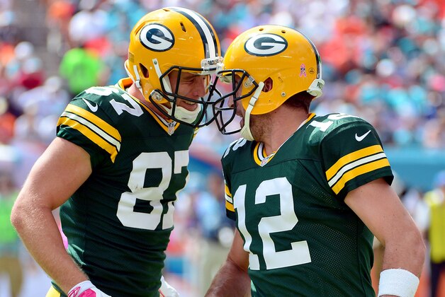 Oct 12, 2014; Miami Gardens, FL, USA; Green Bay Packers quarterback Aaron Rodgers (right) celebrates with wide receiver Jordy Nelson (left) after throwing a touchdown pass against the Miami Dolphins during the first half at Sun Life Stadium. Mandatory Credit: Steve Mitchell-USA TODAY Sports
