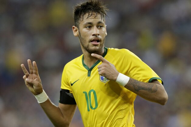 Brazil's Neymar gestures after scoring his third goal against Japan during an international friendly soccer match in Singapore, Tuesday, Oct. 14, 2014. (AP Photo/Wong Maye-E)