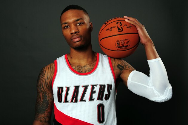 Portland Trail Blazers guard Damian Lillard (0) poses for a photograph during the NBA basketball team's media day in Portland, Ore., Monday, September 29, 2014. (AP Photo/Steve Dykes)