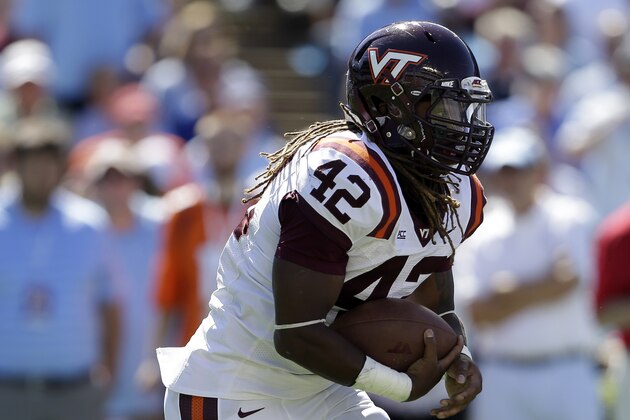 Virginia Tech's Marshawn Williams (42) runs against North Carolina during the first half of an NCAA college football game in Chapel Hill, N.C., Saturday, Oct. 4, 2014. (AP Photo/Gerry Broome)
