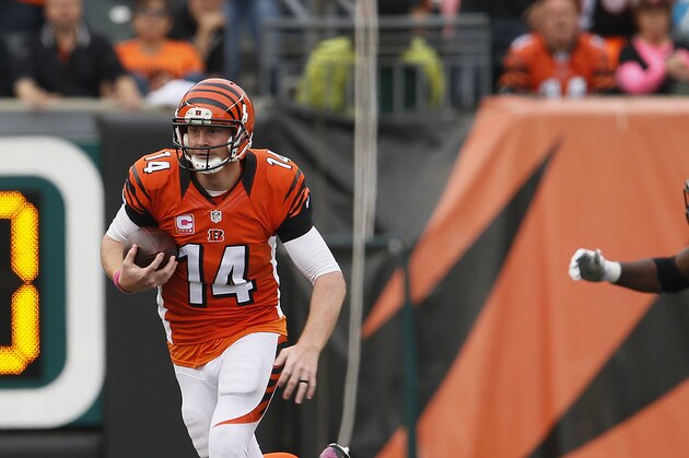 Cincinnati Bengals quarterback Andy Dalton (14) scrambles against the Carolina Panthers in overtime of an NFL football game in Cincinnati Sunday, Oct. 12, 2014. Carolina tied Cincinnati 37-37. (AP Photo/Paul Sancya)