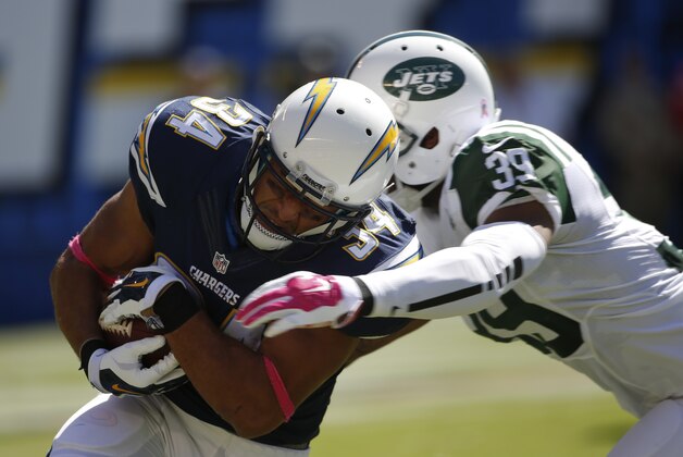 San Diego Chargers running back Donald Brown, left, runs around New York Jets cornerback Antonio Allen during the first half of an NFL football game, Sunday, Oct. 5, 2014, in San Diego. (AP Photo/Lenny Ignelzi)