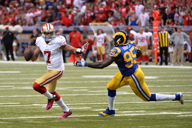 ST LOUIS, MO - OCTOBER 13:   Colin Kaepernick #7 of the San Francisco 49ers tries to avoid the tackle of   William Hayes #95 of the St. Louis Rams in the fourth quarter at Edward Jones Dome on October 13, 2014 in St Louis, Missouri.  (Photo by Michael Thomas/Getty Images)