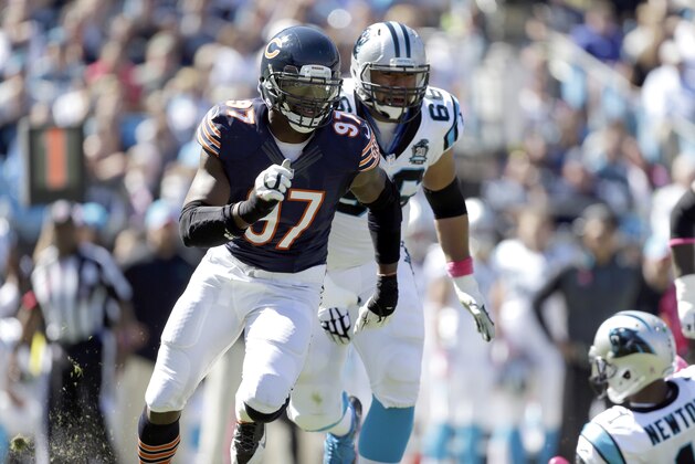Chicago Bears' Willie Young (97) looks for the loose ball he forced as he is chased by Carolina Panthers' Amini Silatolu (66) during the first half of an NFL football game in Charlotte, N.C., Sunday, Oct. 5, 2014. The Panthers won 31-24. (AP Photo/Bob Leverone)