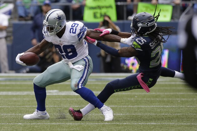 Dallas Cowboys running back DeMarco Murray, left, is tackled by Seattle Seahawks cornerback Richard Sherman, right, in the second half of an NFL football game, Sunday, Oct. 12, 2014, in Seattle. (AP Photo/Elaine Thompson)